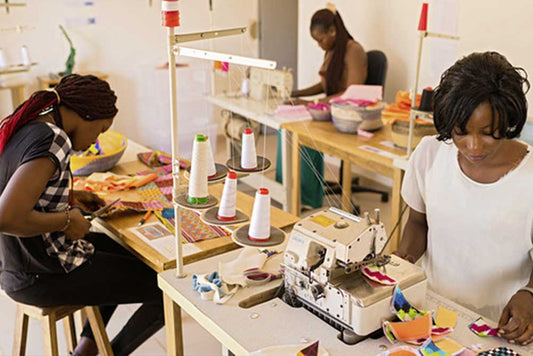 Women sewing reusable sanitary pads at ApiAfrique workshop in Senegal